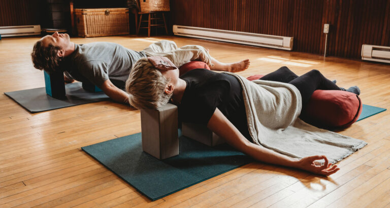 Photo of a man and young man, reclining in a relaxed position.